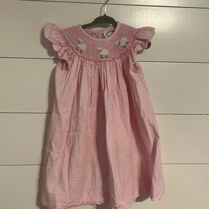 Pink gingham dress with smocking of baby lambs